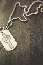 A cross dog tag necklace. 