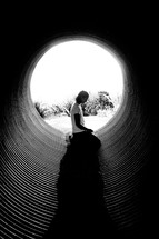 woman in prayer in a tunnel 