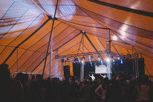 crowds of people under a tent at a concert 