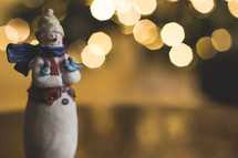snowman figurine and bokeh lights 