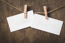blank note cards hanging on a twine with clothespins 