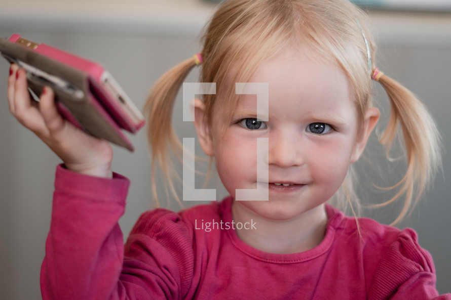 a toddler holding a cellphone 