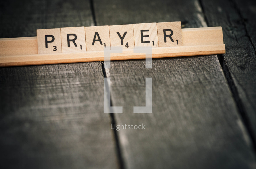 "Prayer" spelled in Scrabble tiles.