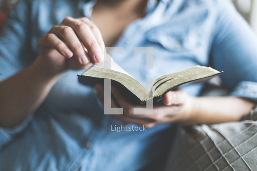 A woman reading a Bible 