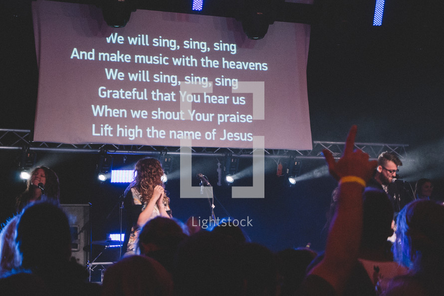 lyrics on a projection screen at a worship service 