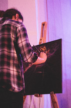 an artist painting on canvas 