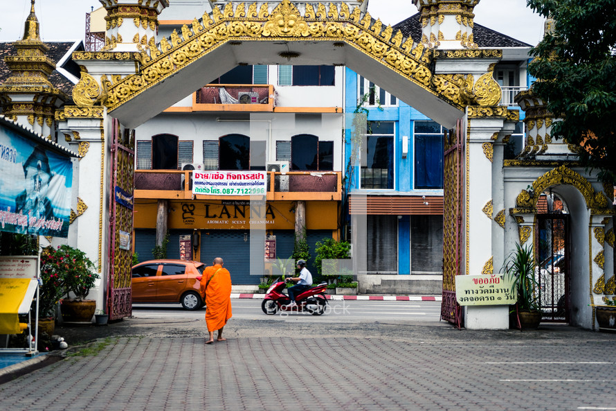 Buddhist monk walking down a street 