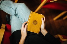 woman sitting with a Bible in her lap 