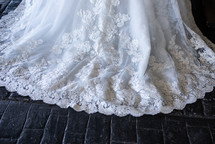 Wedding dress train with lace on black bricks