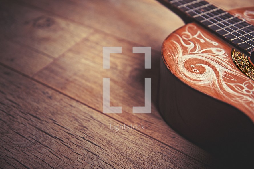 detailed scrolled engraved into a guitar 