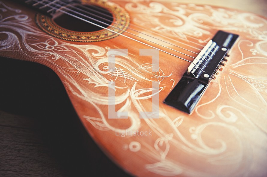 engraved detail on an acoustic guitar 