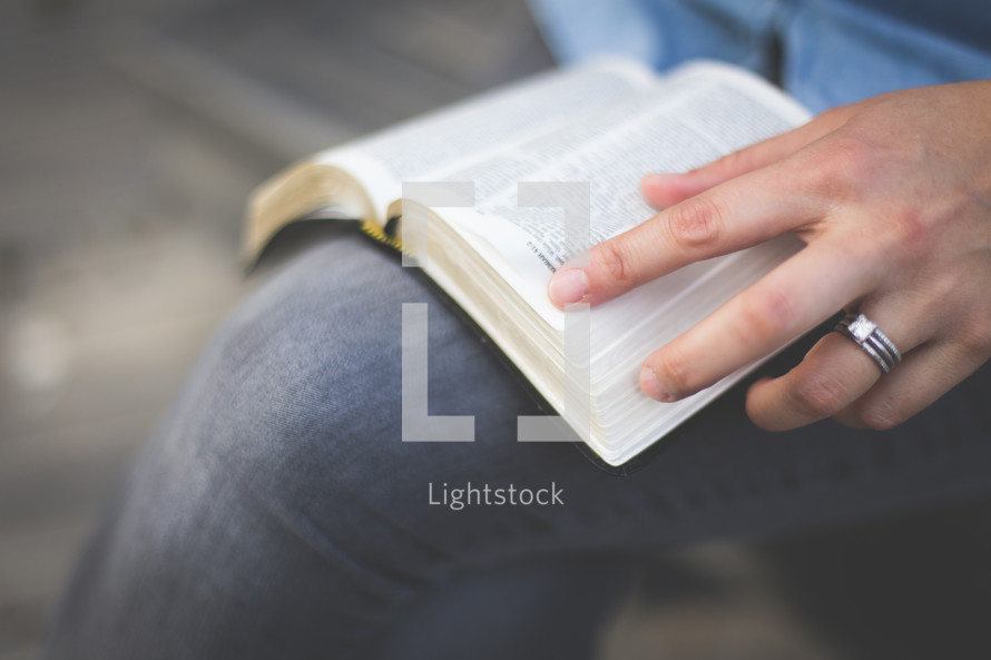 A woman reading a Bible on her lap