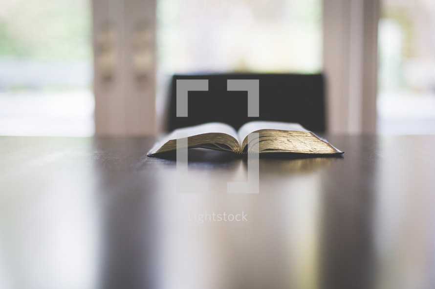 an open Bible on a desk 