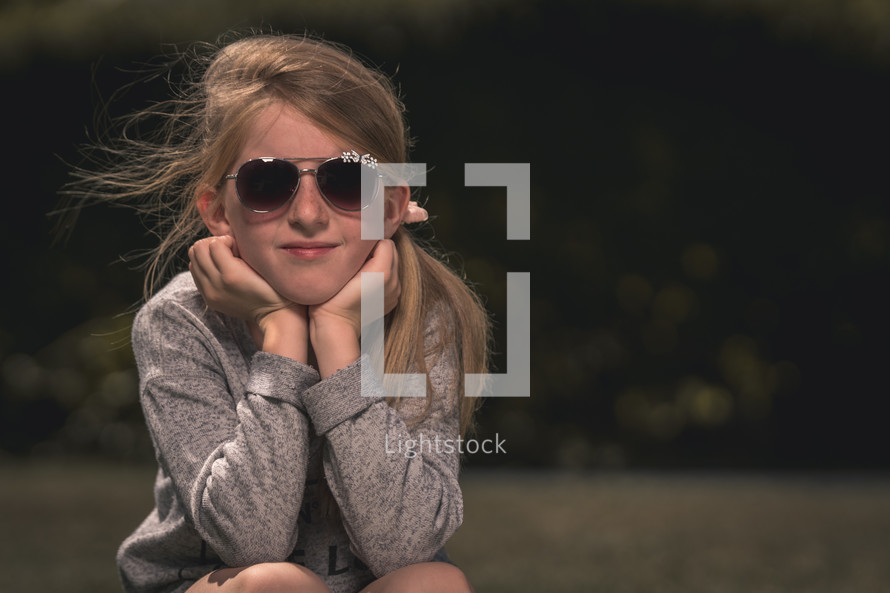 a teen girl in sunglasses 