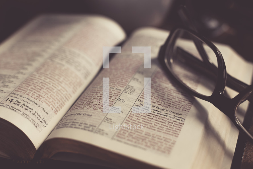 Reading glasses on the pages of a Bible 