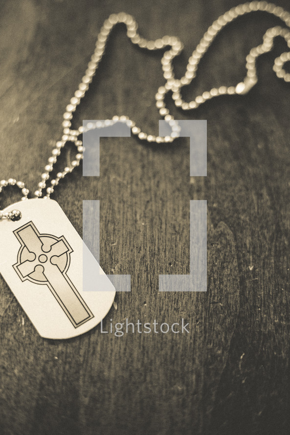 A cross dog tag necklace. 