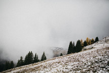 fog in a valley and snow on a mountainside 