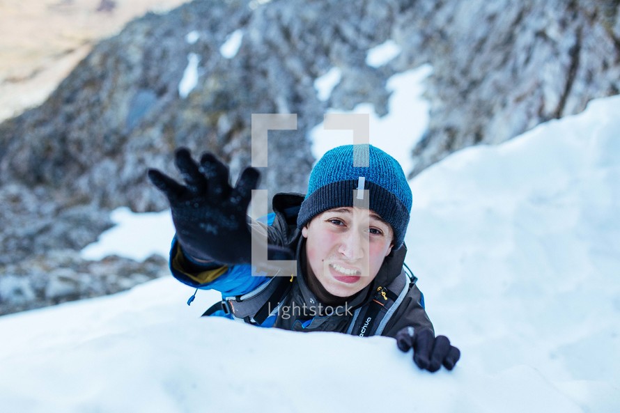 reaching hand of a mountain climbing 