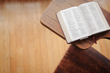 A student desk with a Bible 