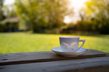 tea cup on a picnic table outdoors 