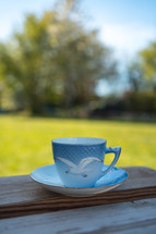 tea cup on a picnic table outdoors 
