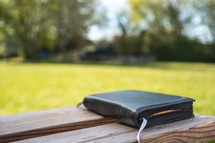 Bible on a bench outdoors 