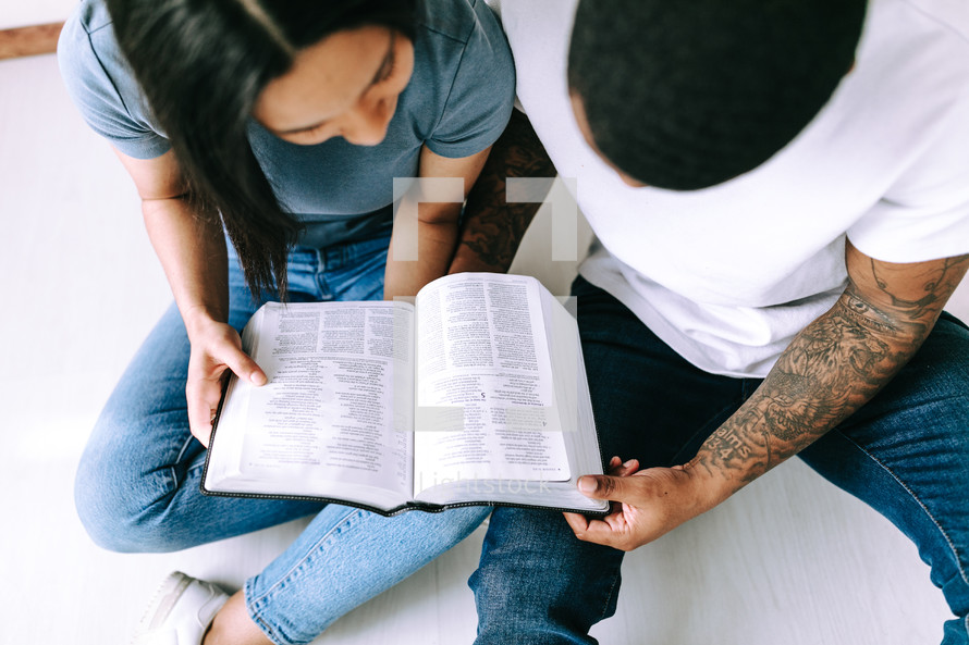 a couple reading a Bible together 