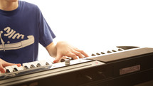 a boy child playing a keyboard 