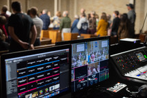 Church audience standing in background with monitors in foreground
