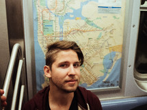 man riding on a subway train 