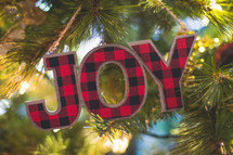 joy Christmas ornament on a Christmas tree