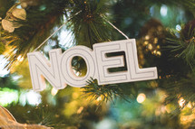 noel Christmas ornament on a Christmas tree