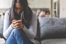 a distressed woman praying 
