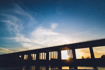 Silhouette of a bridge at sunset.