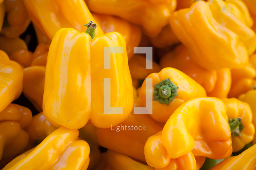 yellow peppers in a pile 