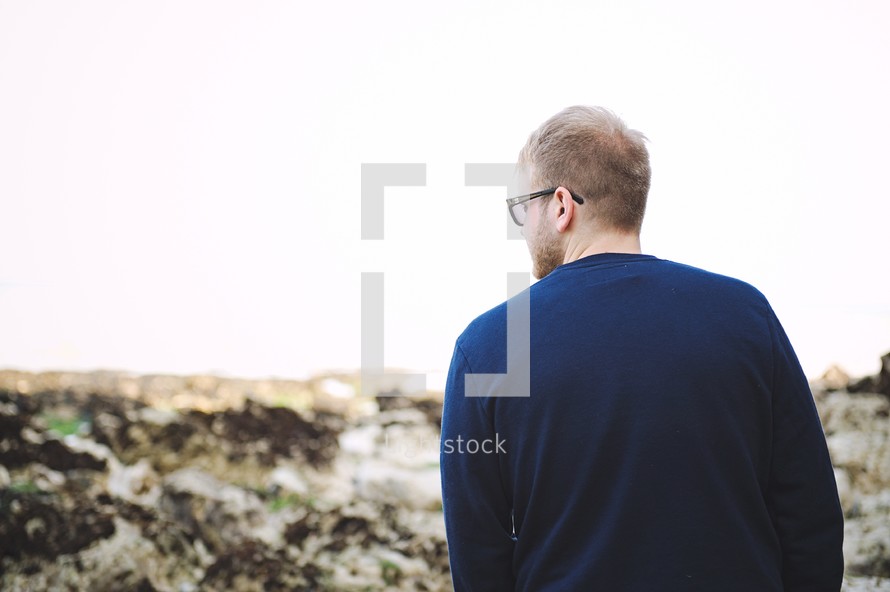 a man standing on a rocky landscape 