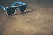 patriotic sunglasses on wood background 