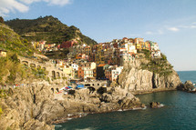 colorful homes on the cliffs of an Italian shore 