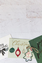 Christmas cards on a white wood background 