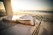 open Bible on a beach