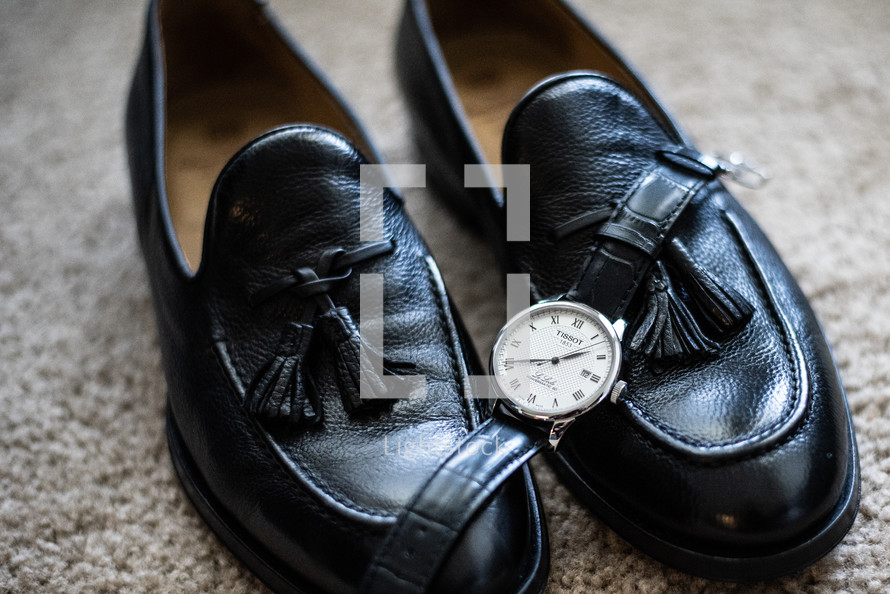 Groom's black shoes with watch