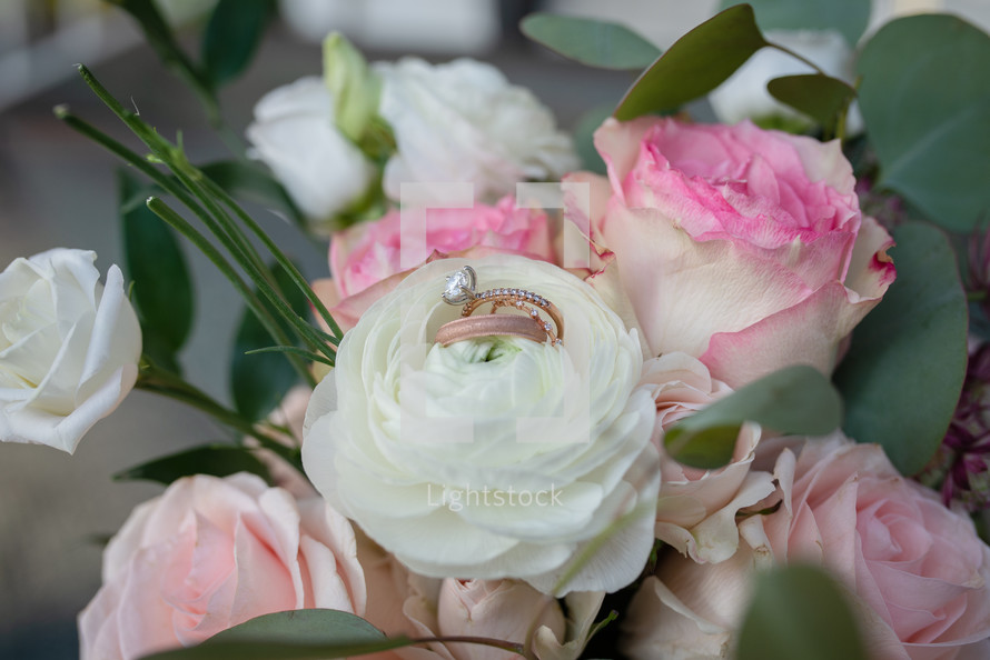 Wedding rings in floral bouquet