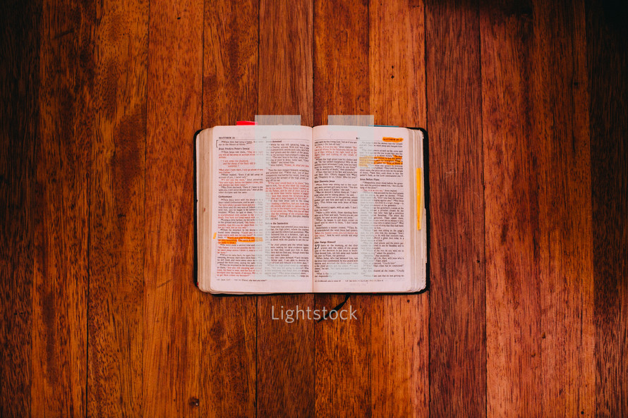 Open Bible on a  wood floor.