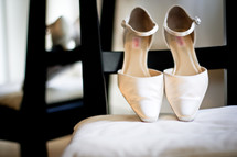 A bide's shoes on a chair before the wedding.