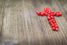 cross of red berries 