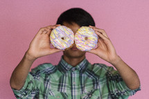 boy holding donuts 
