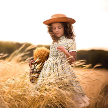 girl picking wheat 