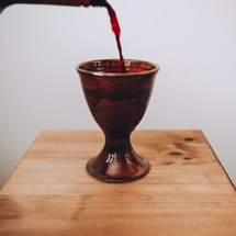 pouring wine into a communion wine chalice 