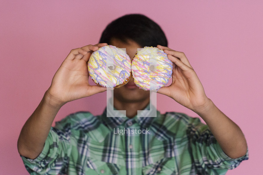 boy holding donuts 