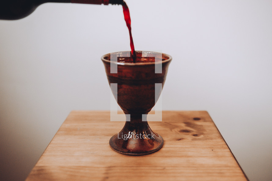 pouring wine into a chalice 
